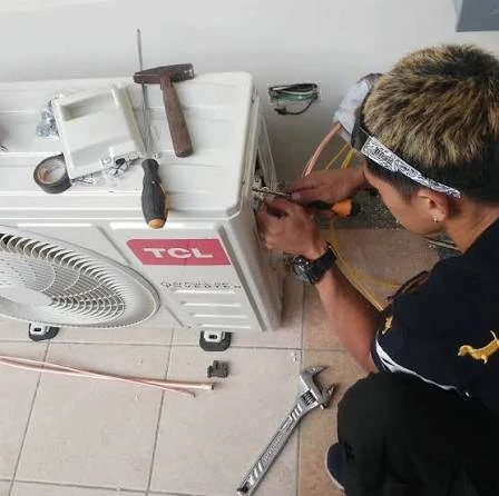 Illustrative technician checking connections on an outdoor air conditioner